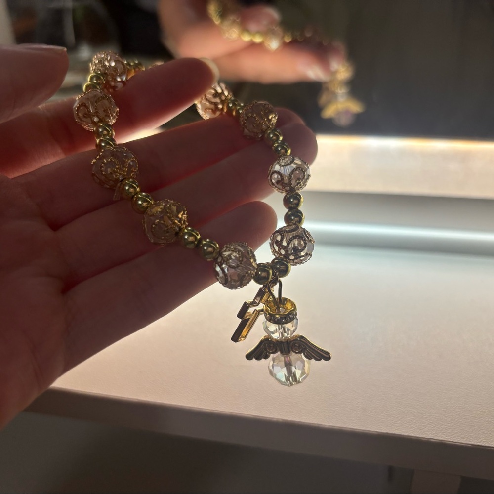 Elegant Gold and Clear Beaded Bracelet with Angel & Cross Charms